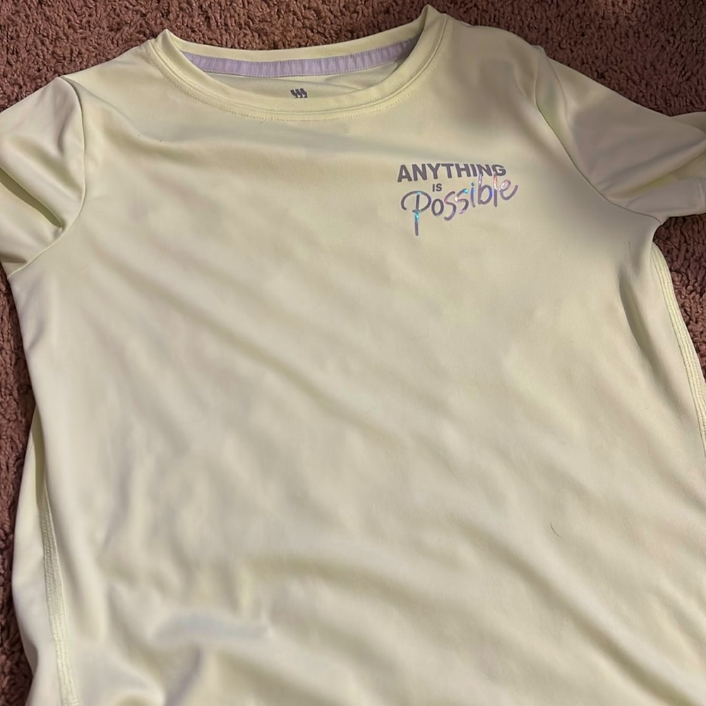 I am selling a green shirt that says anything is possible by  in motion